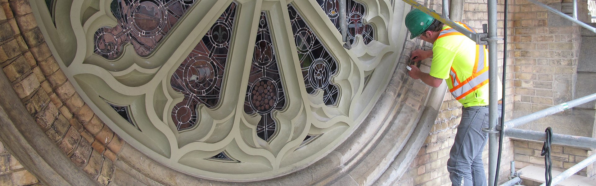 Man undertaking conservation cleaning of a heritage window (Photo: Donovan Pauly)