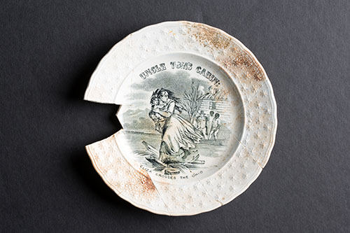 A simple plate adorned with a scene from Uncle Tom’s Cabin