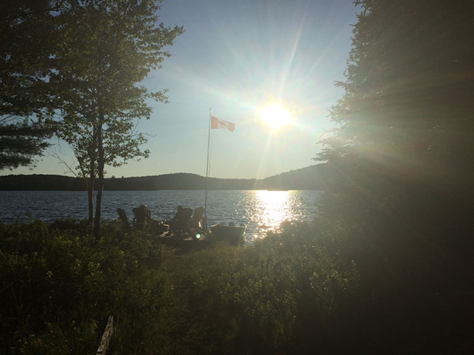 A dock on a lake at sunset