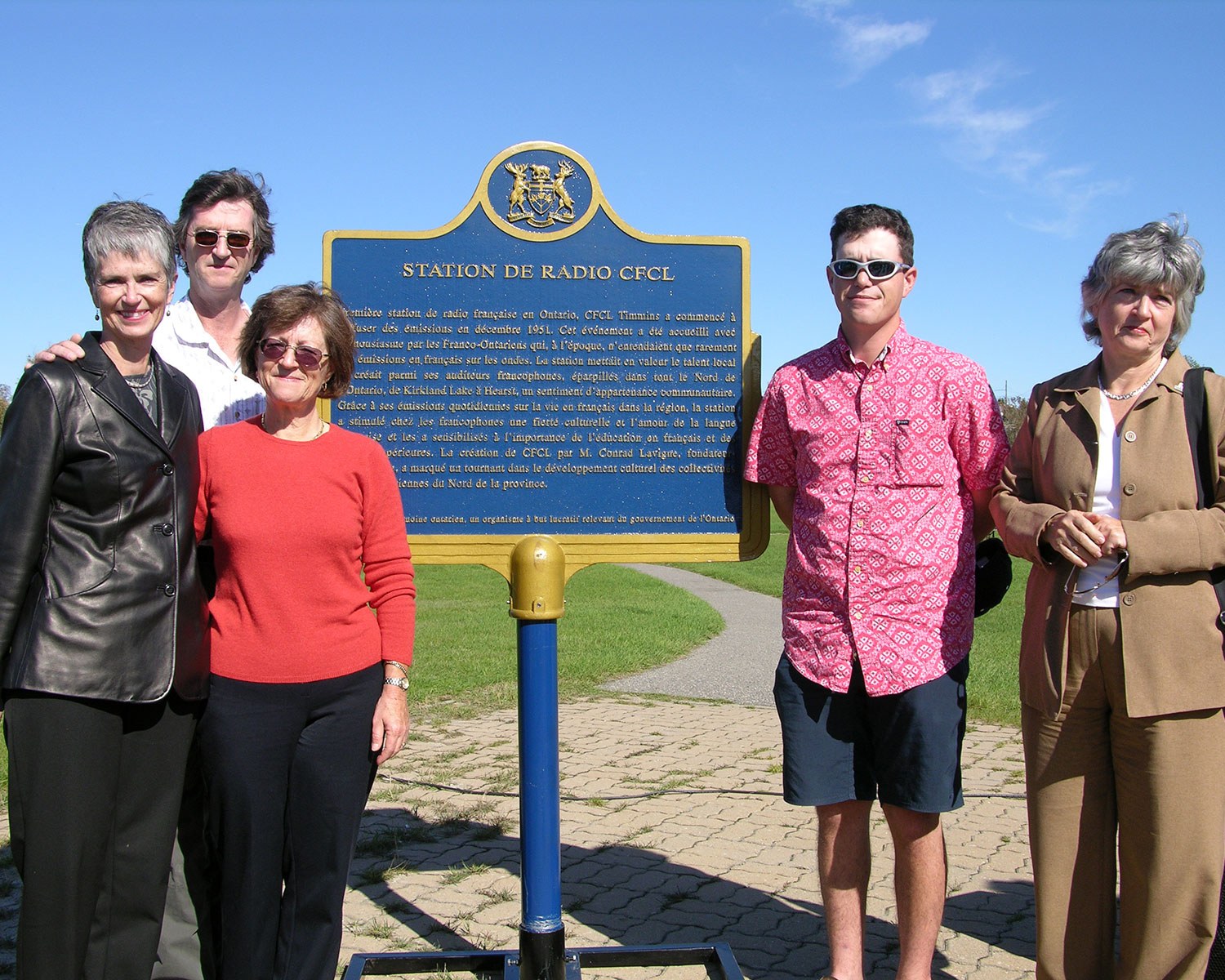 The Lavigne family beside the CFCL Radio plaque in Timmins